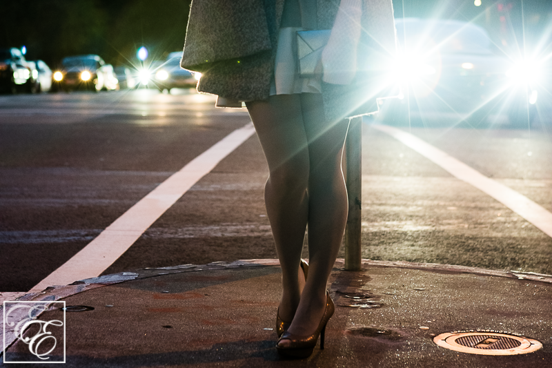 Light grey cape, peplum top, white flared skirt, grey hosiery, arm warmers, and metallic pumps and clutch: close-up of cape and accessories