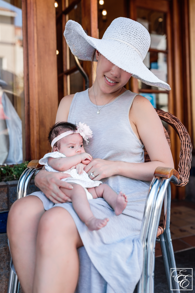 Post-pregnancy new mom style: loosely-flowing dress, wide-brimmed sunhat and sunglasses - and baby!