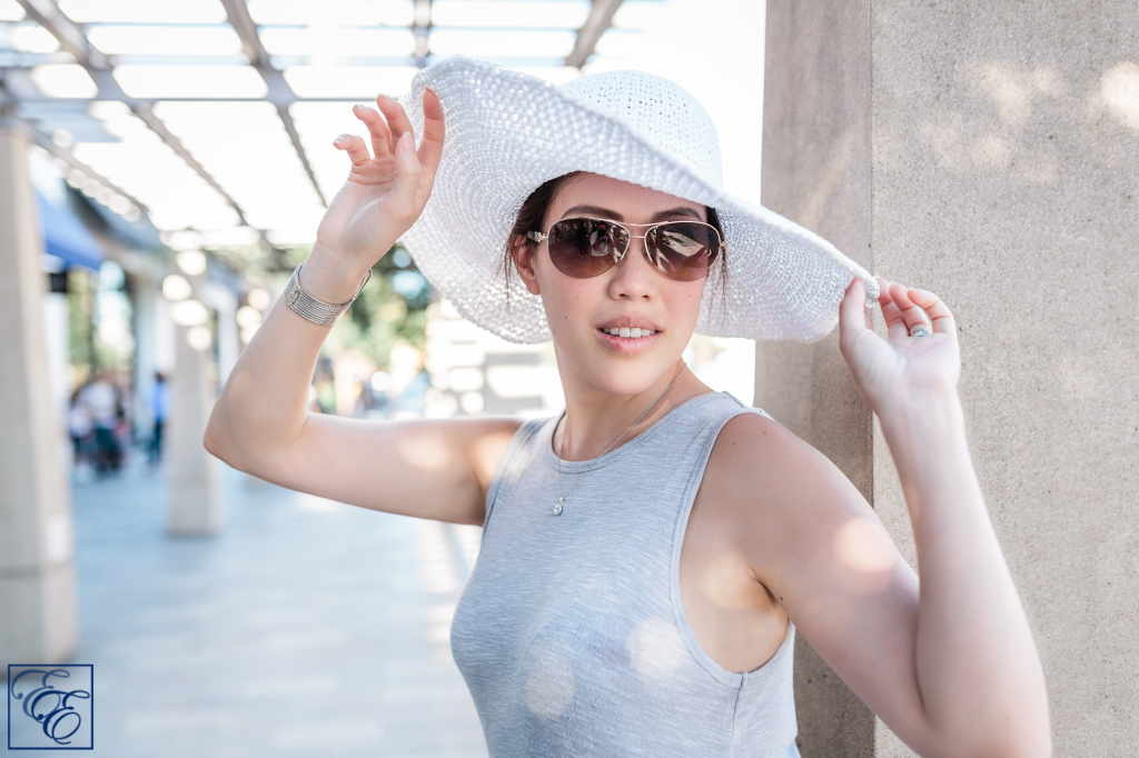 Post-pregnancy new mom style: loosely-flowing dress, wide-brimmed sunhat and sunglasses