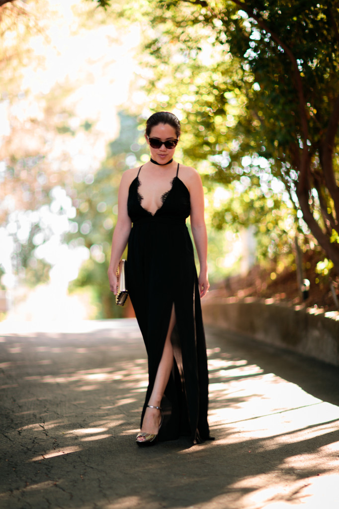 Black maxi dress with side slit and lace plunge v-neck by Tobi. Chanel sunglasses, Cole Haan gold heels, Valentino rockstud bracelet clutch