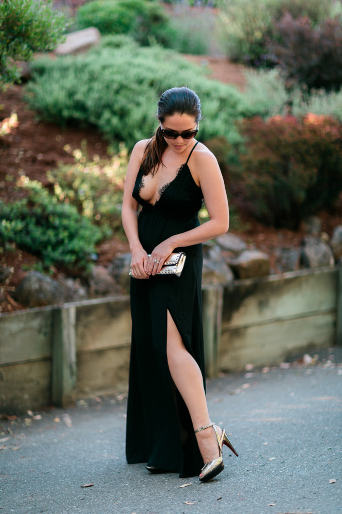 Black maxi dress with side slit and lace plunge v-neck by Tobi. Chanel sunglasses, Cole Haan gold heels, Valentino rockstud bracelet clutch