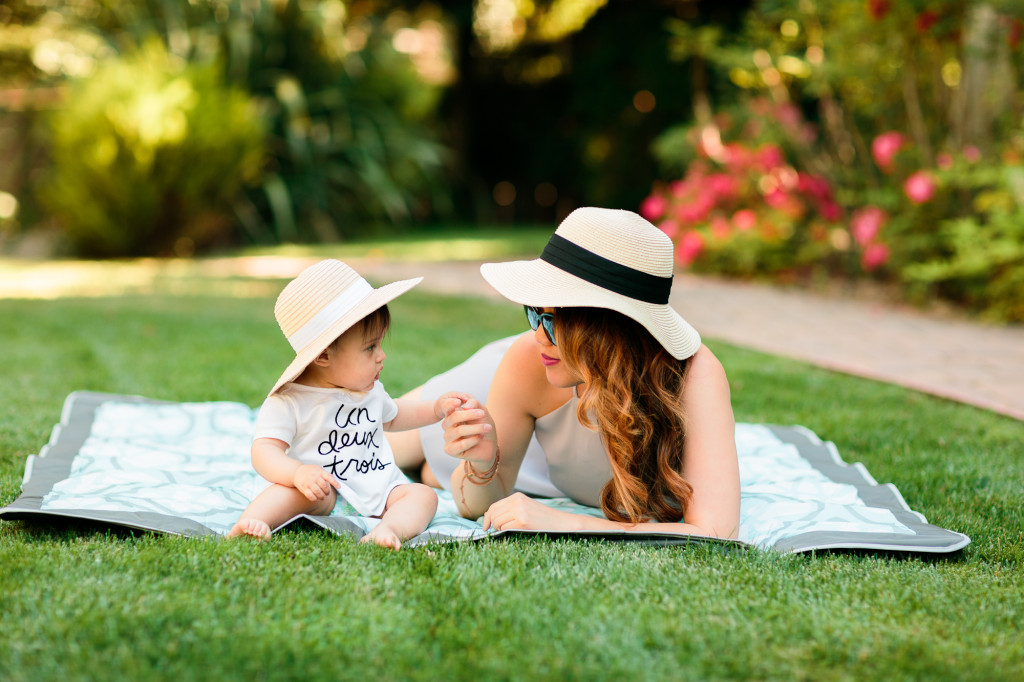 mama wearing Tobi shift dress, Bebe sunhat, Chanel glasses, baby girl wearing Joe Fresh top