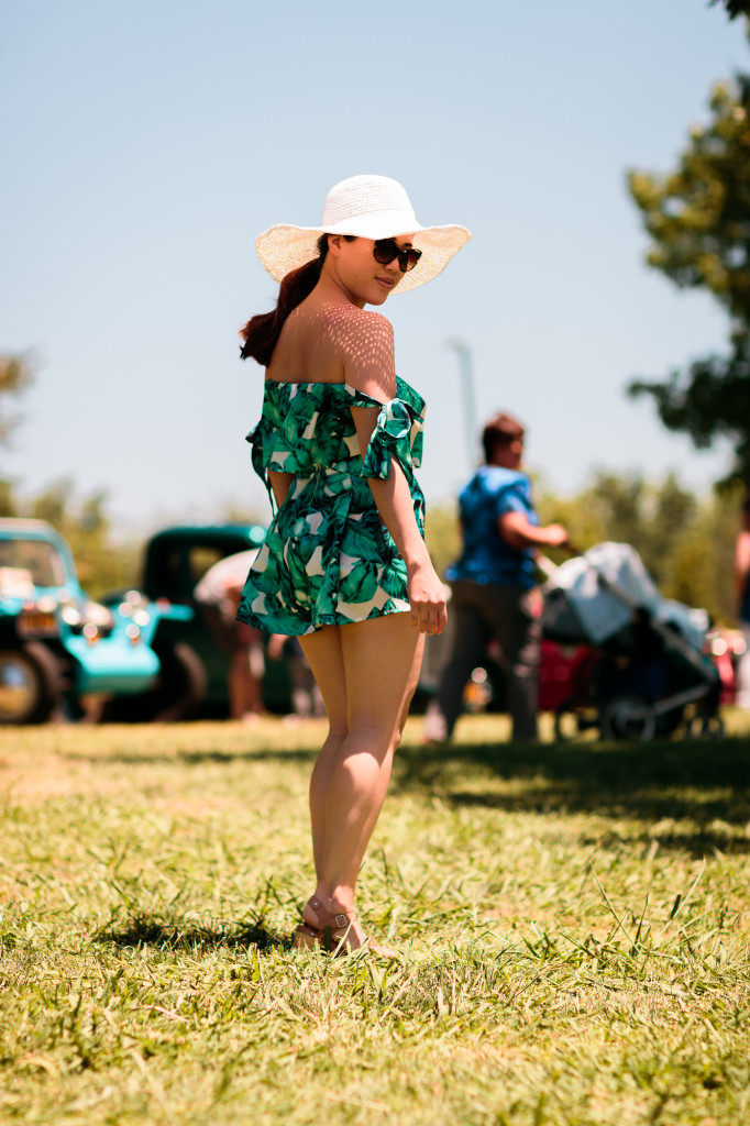 Woman wearing Tobi tropical print romper set (off-shoulder sleeves and shorts) with Hatattack sunhat and Chanel sunglasses